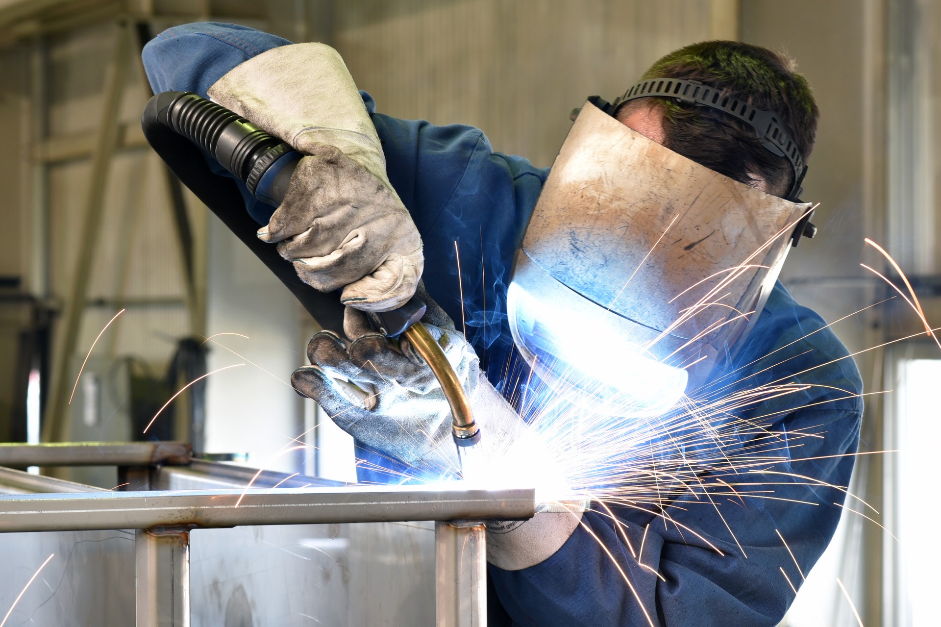 welder works in metal construction - construction and processing of steel components